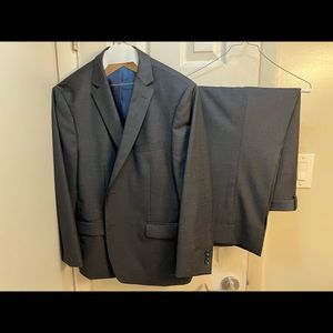 Grey suit worn once. Drycleaned, size in pictures